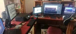 Stacks of photos being digitalized