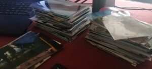 Stacks of photos being digitalized